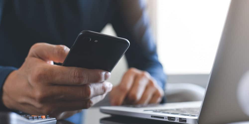 man dialing into a smart phone