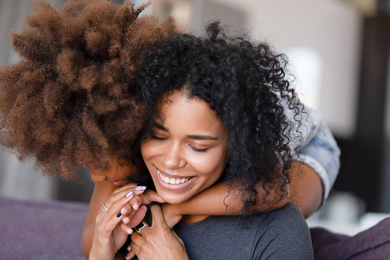 two people hugging and smiling